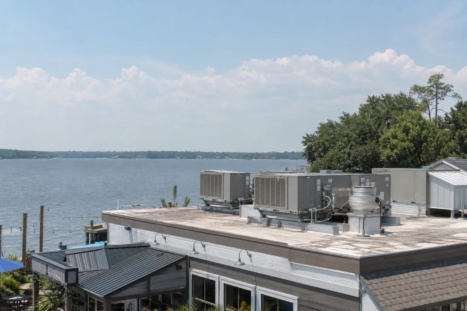 Air Solutions technician servicing rooftop commercial HVAC package units at a Loxley, Alabama home, illustrating "Restaurant HVAC: Surviving Peak Summer Service Without Failures"