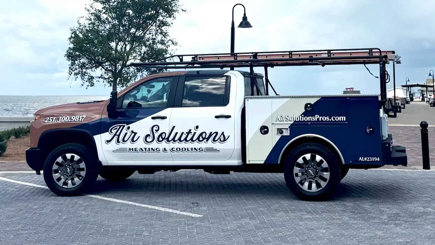 Air Solutions Heating & Cooling service truck at the Fairhope pier on Mobile Bay, serving Baldwin County, Alabama.